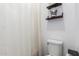 Bathroom featuring a shower, toilet, and stylish shelving for essentials at 2067 N Marketside Ave, Buckeye, AZ 85396