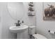 Powder room featuring a modern sink, round mirror, decorative shelves, and an animal print at 2067 N Marketside Ave, Buckeye, AZ 85396