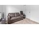 Bedroom with a gray couch, office chair, and closet for flexible living at 2067 N Marketside Ave, Buckeye, AZ 85396