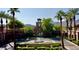 Beautiful entrance to Verrado Golf Club featuring lush landscaping, water feature, and palm trees at 2067 N Marketside Ave, Buckeye, AZ 85396