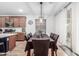 Dining area featuring modern light fixture and sliding glass doors to the outside at 2067 N Marketside Ave, Buckeye, AZ 85396