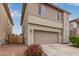 Two-story home featuring a two-car garage, desert landscaping, and modern design at 2067 N Marketside Ave, Buckeye, AZ 85396