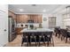 Spacious kitchen with stainless steel appliances, wooden cabinets, large island and stylish bar stools at 2067 N Marketside Ave, Buckeye, AZ 85396