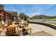 Inviting outdoor patio with comfortable seating and scenic views of the golf course and lake at 2067 N Marketside Ave, Buckeye, AZ 85396
