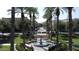 Picturesque view of a town square featuring a fountain and palm trees leading to a charming street at 2067 N Marketside Ave, Buckeye, AZ 85396