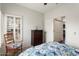 Inviting bedroom with a dark wood dresser, shuttered windows, and a comfortable-looking floral comforter at 22420 N 147Th Dr, Sun City West, AZ 85375