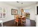 Cozy dining area with wood table, chairs, and sliding glass door to backyard at 22420 N 147Th Dr, Sun City West, AZ 85375