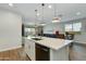 Open kitchen with a large island, quartz countertop, pendant lighting, and stainless steel appliances at 22853 E Estrella Rd, Queen Creek, AZ 85142