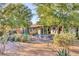 Back yard patio with covered outdoor seating area, desert landscaping, cacti, and trees at 2409 N 57Th St, Scottsdale, AZ 85257