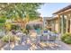 Spacious backyard featuring a dining set, lush greenery, and shade trees at 2409 N 57Th St, Scottsdale, AZ 85257