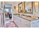 Chic bathroom with double sinks, stylish mirrors, and a view into an adjacent living space at 2409 N 57Th St, Scottsdale, AZ 85257