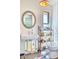 Modern bathroom with unique round mirror, open shelving, and elegant fixtures at 2409 N 57Th St, Scottsdale, AZ 85257