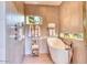 Serene bathroom with a modern freestanding tub, neutral tile, and decorative accents for a spa-like retreat at 2409 N 57Th St, Scottsdale, AZ 85257