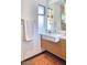 Contemporary bathroom featuring a trough sink, wood cabinets, and stylish lighting at 2409 N 57Th St, Scottsdale, AZ 85257