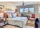 Comfortable bedroom with natural light, soft bedding, stylish decor, and wood-look flooring at 2409 N 57Th St, Scottsdale, AZ 85257