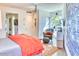 Stylish bedroom with a decorative rug, modern art, and a comfortable chair and ottoman seating area at 2409 N 57Th St, Scottsdale, AZ 85257