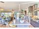 Open-concept kitchen featuring gray cabinets, an island with bar seating, and stainless steel appliances at 2409 N 57Th St, Scottsdale, AZ 85257