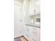 Laundry room with gray counter, white cabinets, and door at 2409 N 57Th St, Scottsdale, AZ 85257