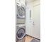 Stacked Washer and Dryer in Laundry Room, white door, and gray carpet at 2409 N 57Th St, Scottsdale, AZ 85257