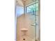 Modern shower with glass doors, tiled walls, and a built-in corner seat at 2409 N 57Th St, Scottsdale, AZ 85257