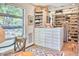 Spacious walk-in closet with custom built-ins, drawers, shelving and storage solutions under a large window at 2409 N 57Th St, Scottsdale, AZ 85257
