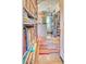 Walk-in closet with extensive shelving, clothing racks, and a colorful rug leading to a window at 2409 N 57Th St, Scottsdale, AZ 85257
