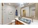 Stylish bathroom features a unique glass sink, wood cabinets and ample counter space at 2410 E Cholla St, Phoenix, AZ 85028