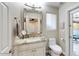 Elegant bathroom with a marble countertop, large mirror, and access to an outdoor patio at 2410 E Cholla St, Phoenix, AZ 85028