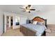 Spacious bedroom featuring a ceiling fan, plush carpet, and a doorway to additional rooms at 2410 E Cholla St, Phoenix, AZ 85028