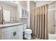 Bathroom showcasing a white vanity, granite countertop, wall cabinet, toilet, and bathtub with curtain at 2425 W Bronco Butte Trl # 2008, Phoenix, AZ 85085