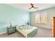 Cozy bedroom with a ceiling fan and a large window at 2425 W Bronco Butte Trl # 2008, Phoenix, AZ 85085