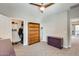 Bedroom featuring an empty bookshelf, purple file cabinet, and a large closet full of clothes at 2425 W Bronco Butte Trl # 2008, Phoenix, AZ 85085