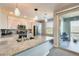 Modern kitchen featuring a granite island, stainless steel appliances, and stylish pendant lighting at 2425 W Bronco Butte Trl # 2008, Phoenix, AZ 85085