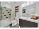Stylish bathroom with a modern vanity, decorative shelves, and tiled shower-tub combo at 26065 W Yukon Dr, Buckeye, AZ 85396