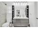 Bright bathroom featuring a modern double sink vanity, a toilet, and open storage shelves at 26065 W Yukon Dr, Buckeye, AZ 85396