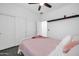 Bright bedroom featuring a plush pink comforter, white walls, and closet at 26065 W Yukon Dr, Buckeye, AZ 85396