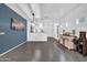 Open-concept dining area with tile floors, a stylish wine rack, and elegant lighting at 26065 W Yukon Dr, Buckeye, AZ 85396