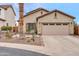 Charming single-story home featuring a two-car garage and drought-tolerant landscaping at 26065 W Yukon Dr, Buckeye, AZ 85396