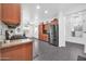 View of the kitchen with stainless steel appliances, wood cabinets, and tile floors at 26065 W Yukon Dr, Buckeye, AZ 85396