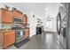 Open-concept kitchen with stainless steel appliances, wood cabinets, and tile flooring at 26065 W Yukon Dr, Buckeye, AZ 85396