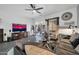 Comfortable living room with a ceiling fan, modern decor, and natural light at 26065 W Yukon Dr, Buckeye, AZ 85396