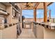 Outdoor kitchen boasts a built-in grill, counter space, and ceiling fan for comfortable outdoor cooking at 26065 W Yukon Dr, Buckeye, AZ 85396