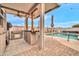 Inviting outdoor kitchen and dining area featuring a built-in grill and a refreshing swimming pool at 26065 W Yukon Dr, Buckeye, AZ 85396