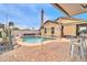 A beautiful backyard featuring a private pool and covered patio area at 26065 W Yukon Dr, Buckeye, AZ 85396