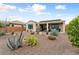 Spacious backyard featuring desert landscaping and a covered patio, perfect for outdoor enjoyment at 26234 W Matthew Dr, Buckeye, AZ 85396