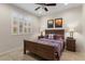 This comfortable bedroom features a ceiling fan, neutral walls, and bright window at 26234 W Matthew Dr, Buckeye, AZ 85396