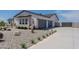 View of the exterior, driveway, and xeriscaped front yard of a charming single-story home at 27776 N Gary Rd, Queen Creek, AZ 85144