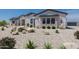 Charming single-story home with xeriscaping, decorative boulders, and vibrant barrel cactus at 27776 N Gary Rd, Queen Creek, AZ 85144