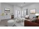 Bright living room with a wet bar, sofa, sitting chairs, and a view of the front yard at 27776 N Gary Rd, Queen Creek, AZ 85144