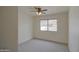 Bright bedroom features a ceiling fan and a large window with neighborhood views at 310 N Mountain View Rd, Apache Junction, AZ 85119